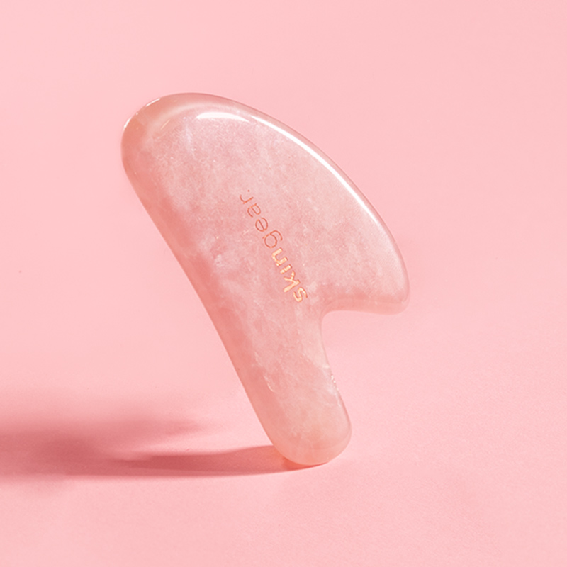 Facial Lifting Tool Gua She Rose Quartz in Pink heart shaped massager reduces puffiness and improves lymphatic drainage and blood circulation